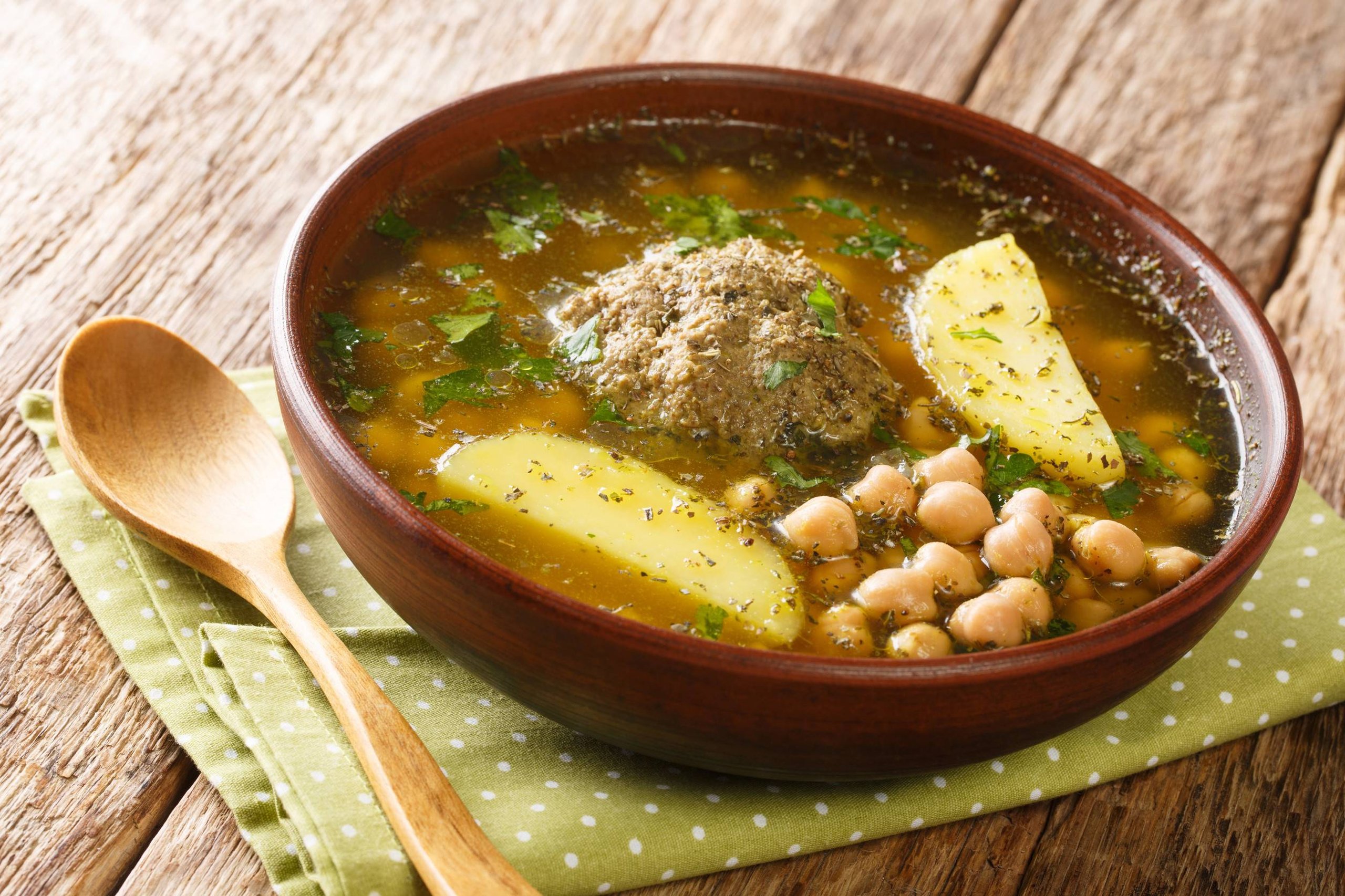 Bozbash soup cooked from lamb meatballs, chickpeas, vegetables and herbs