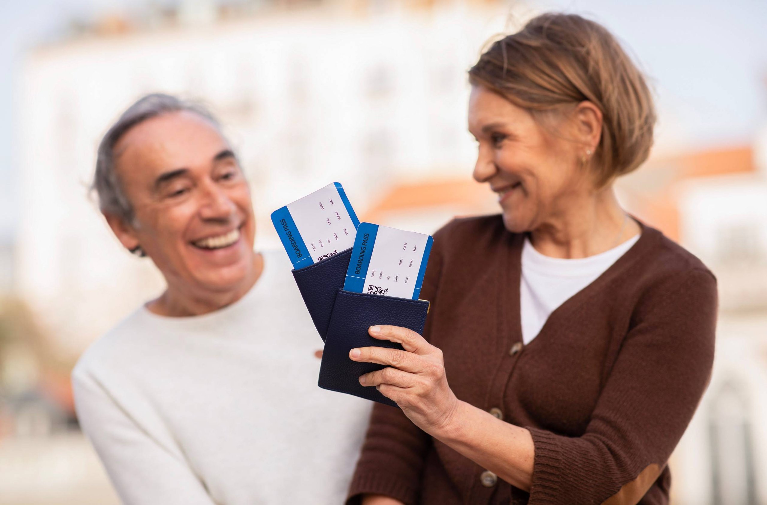Senior Tourists Couple Holding Boarding Passes And Travel Passports Outdoors