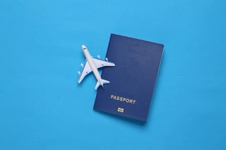 Passport With Toy Airplane Flat Lay