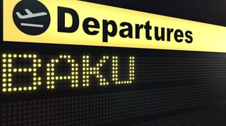 flight to baku on international airport departures board travelling to azerbaijan conceptual